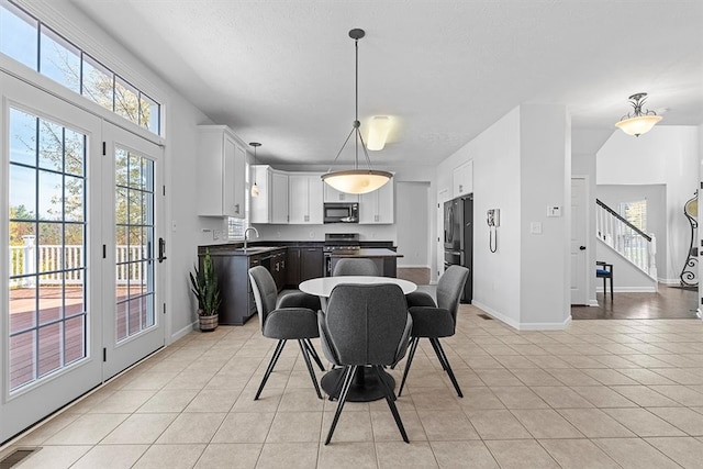 dining room featuring sink and light tile patterned flooring