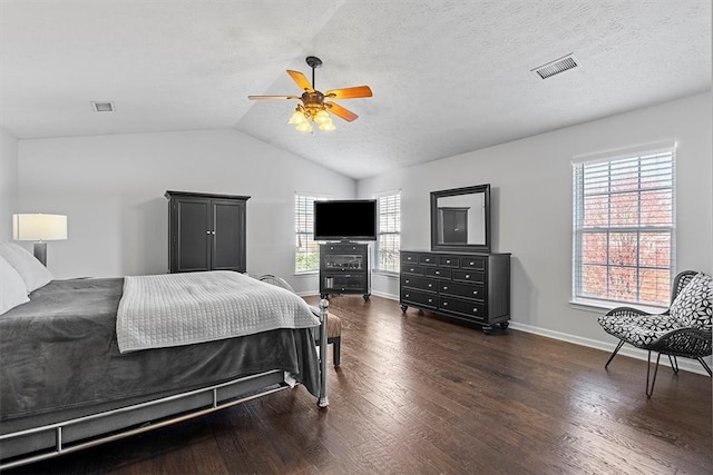 bedroom featuring dark wood-type flooring, lofted ceiling, a textured ceiling, and ceiling fan