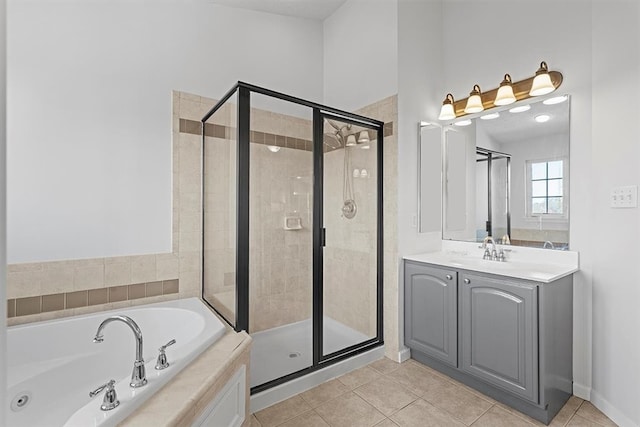 bathroom with tile patterned flooring, vanity, and independent shower and bath