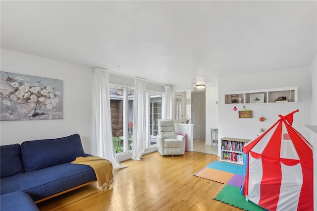 recreation room with hardwood / wood-style floors