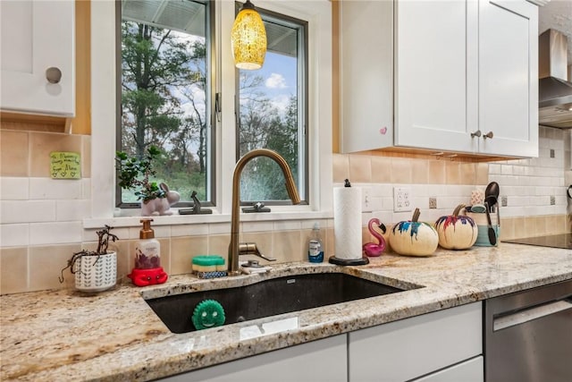 room details featuring dishwasher, white cabinetry, sink, backsplash, and light stone counters