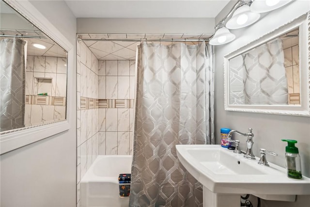 bathroom featuring sink and shower / bath combination with curtain