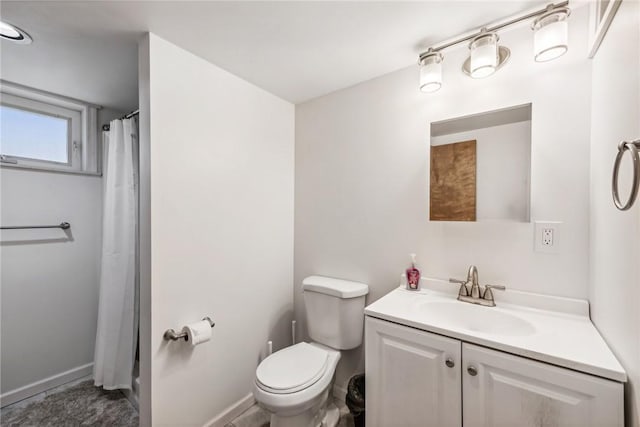 bathroom with vanity, curtained shower, and toilet