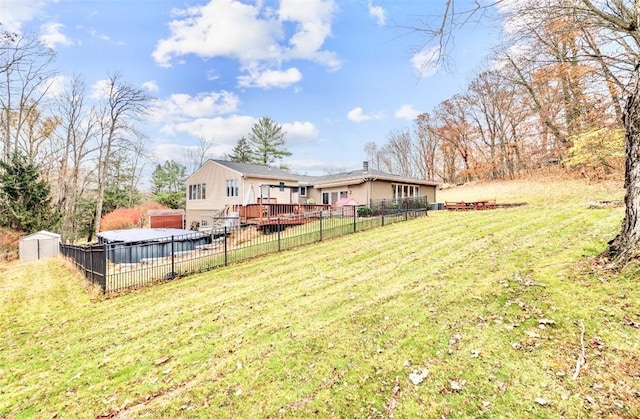 view of yard featuring a deck and a shed