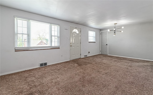 foyer featuring carpet floors and a healthy amount of sunlight