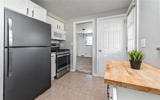 969 Kirsopp Ave, Banksville/Westwood, PA 15220 - kitchen featuring stainless steel appliances, white cabinetry, and light tile patterned flooring