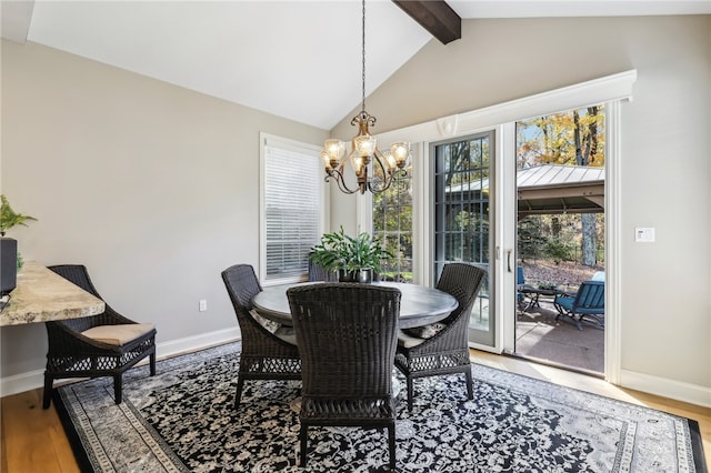 dining space with hardwood / wood-style floors, lofted ceiling with beams, and a notable chandelier