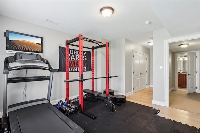 workout room with hardwood / wood-style flooring