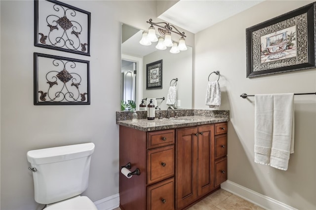 bathroom with tile patterned flooring, vanity, and toilet