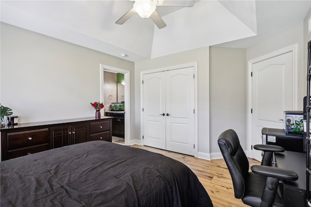 bedroom featuring ceiling fan, a closet, light wood-type flooring, and vaulted ceiling