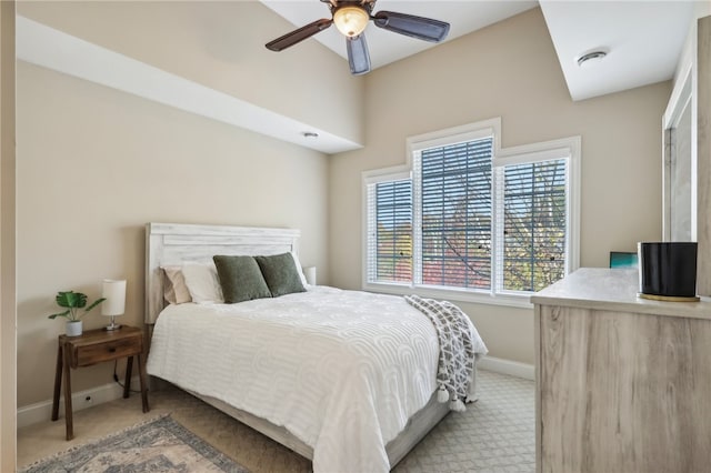 bedroom with light carpet and ceiling fan