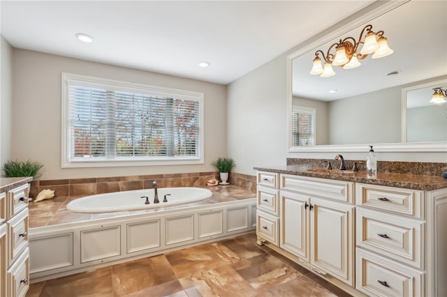 bathroom featuring vanity and a washtub