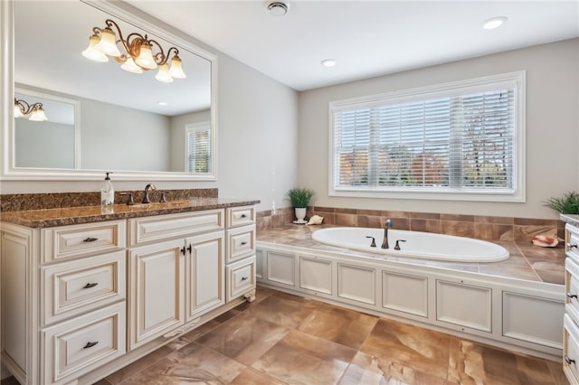 bathroom with vanity and a tub