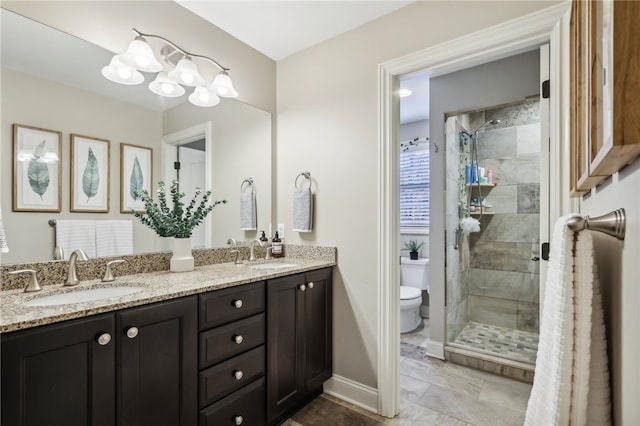 bathroom featuring toilet, vanity, and walk in shower