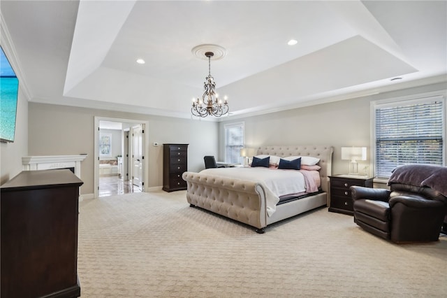 carpeted bedroom with multiple windows, an inviting chandelier, and a tray ceiling