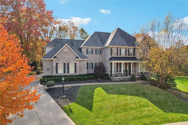 view of front facade with a front lawn and covered porch