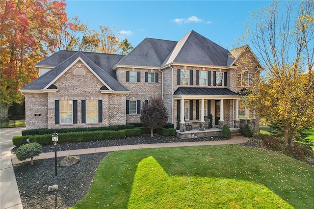 view of front of house featuring a porch and a front lawn