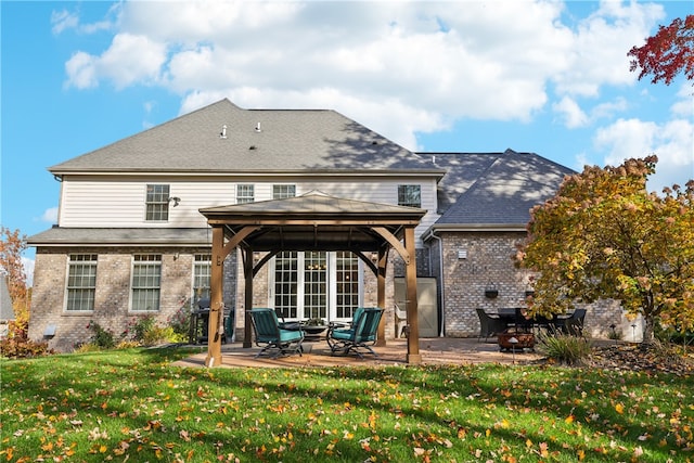 rear view of property with a patio area, a yard, and a gazebo