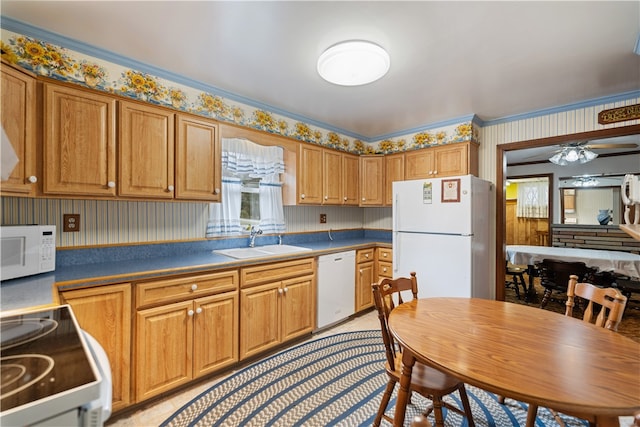 kitchen with white appliances, ceiling fan, sink, and crown molding