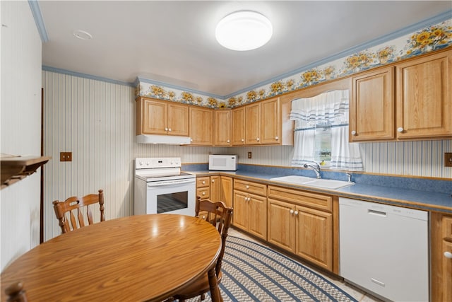 kitchen featuring white appliances, sink, and crown molding