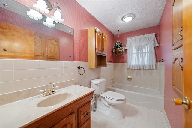 bathroom featuring tile walls, tile patterned floors, vanity, a textured ceiling, and a tub to relax in