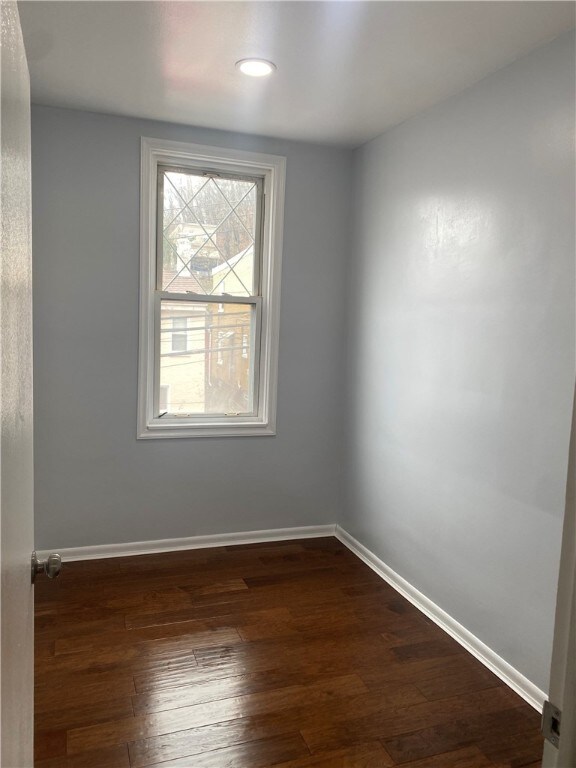 empty room featuring dark hardwood / wood-style floors