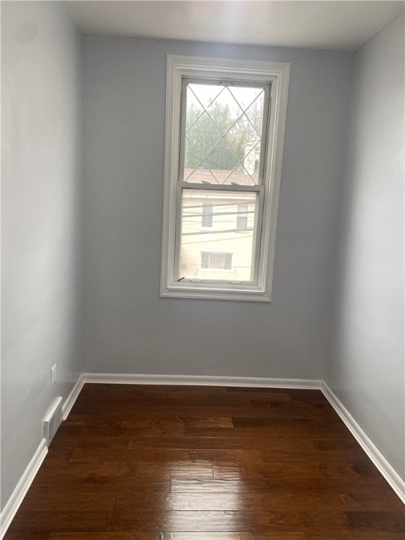 spare room featuring dark hardwood / wood-style flooring