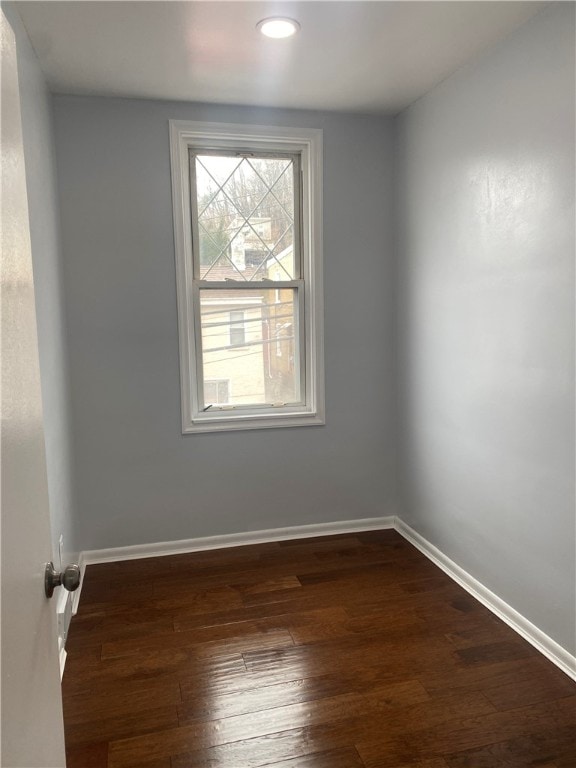 spare room featuring dark hardwood / wood-style flooring