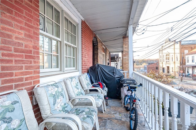 balcony featuring area for grilling and a porch