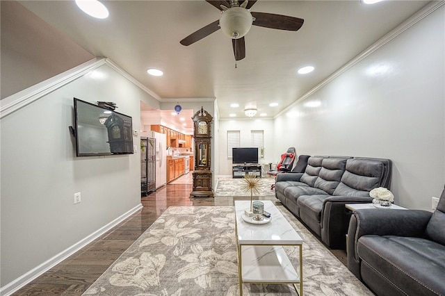 living room featuring ceiling fan, dark hardwood / wood-style flooring, and ornamental molding