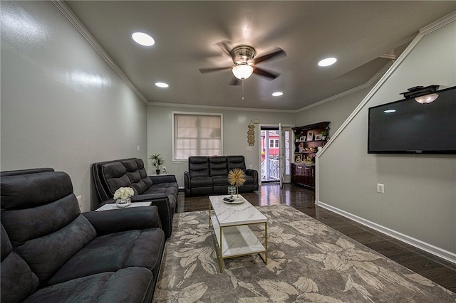 living room featuring dark hardwood / wood-style flooring, ornamental molding, and ceiling fan