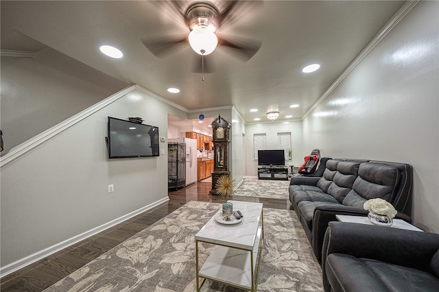 living room with dark hardwood / wood-style flooring, ceiling fan, and crown molding