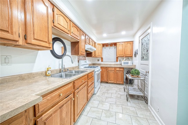 kitchen featuring light tile patterned floors, white appliances, and sink