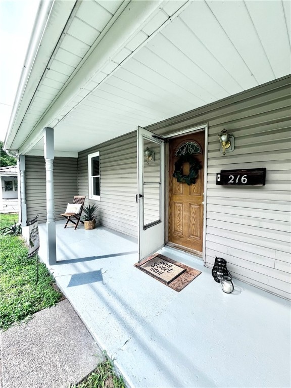 doorway to property featuring a porch