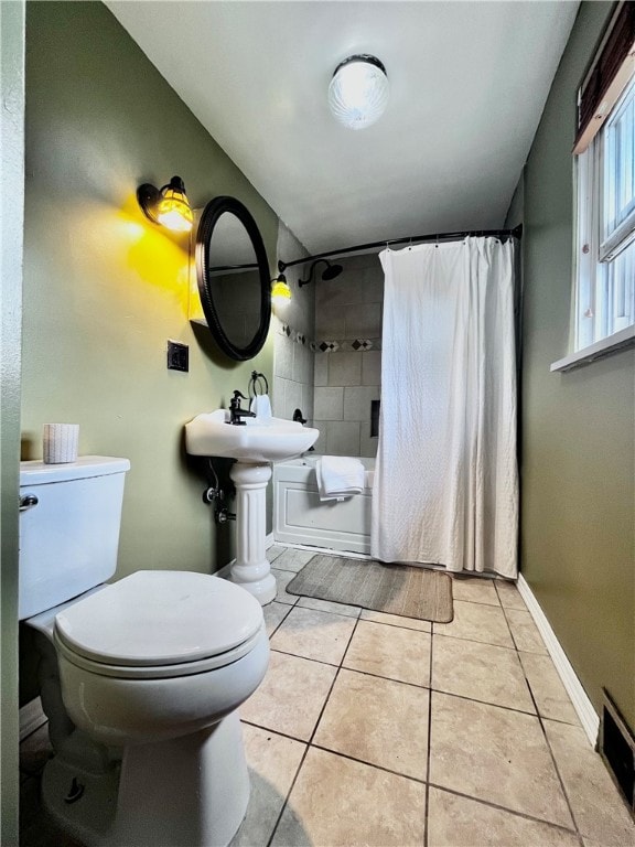 bathroom with tile patterned floors, toilet, and shower / bath combination with curtain