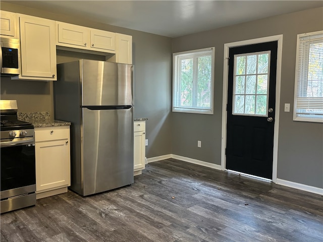 kitchen featuring white cabinets, stainless steel appliances, and dark hardwood / wood-style flooring