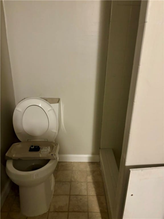 bathroom featuring toilet and tile patterned floors