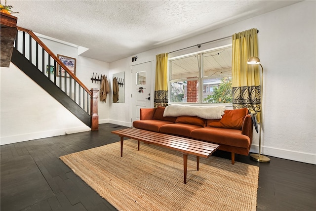 living room featuring dark hardwood / wood-style floors and a textured ceiling