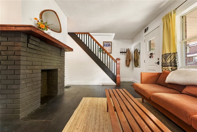 interior space featuring dark hardwood / wood-style flooring, a textured ceiling, and a fireplace