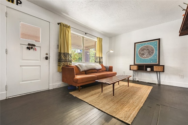 living room with dark hardwood / wood-style flooring and a textured ceiling