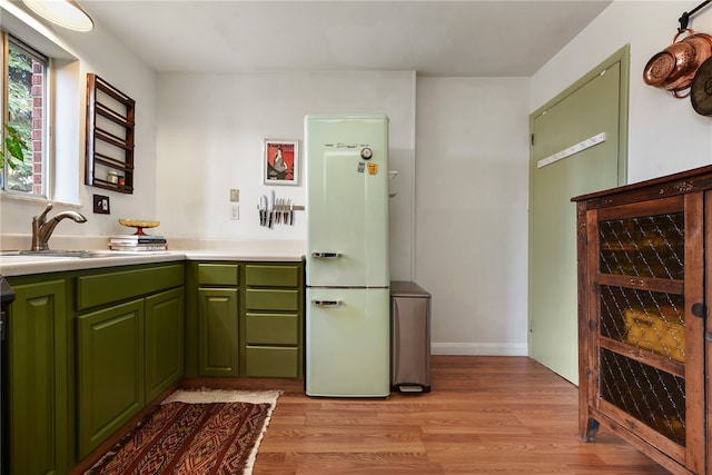 kitchen with light hardwood / wood-style flooring, sink, white fridge, and wine cooler