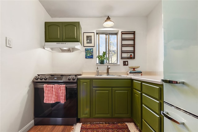 kitchen with light hardwood / wood-style floors, green cabinets, sink, white fridge, and electric stove