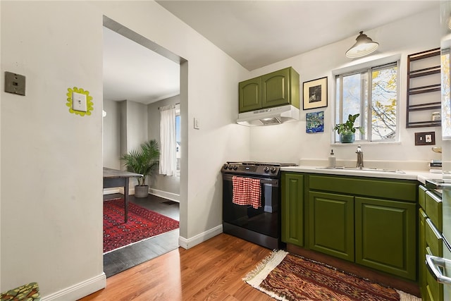 kitchen with hardwood / wood-style flooring, stove, sink, and green cabinetry