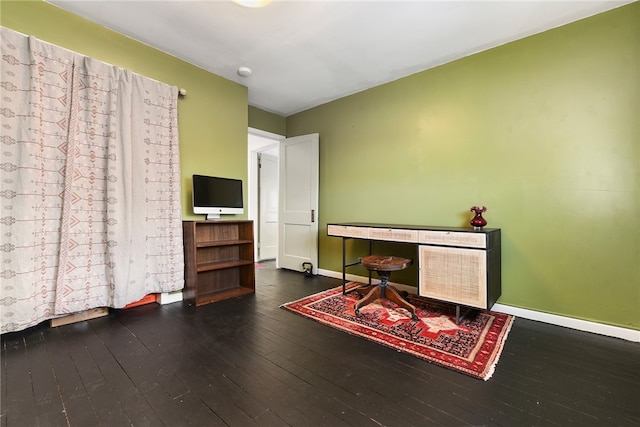 home office with dark hardwood / wood-style floors