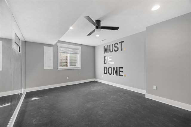 empty room with electric panel and ceiling fan