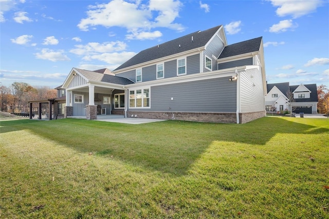 back of property featuring a yard and a patio