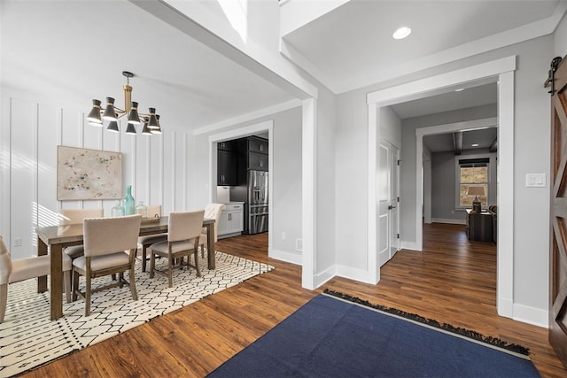 dining room featuring dark hardwood / wood-style flooring and a notable chandelier