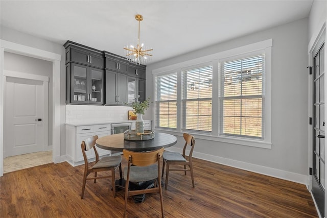 dining space featuring a chandelier and dark hardwood / wood-style flooring