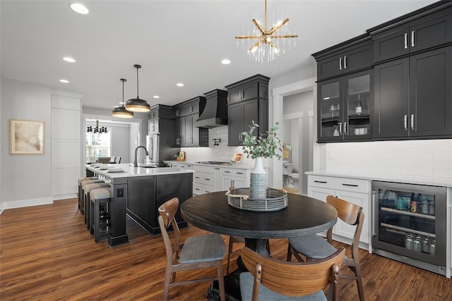 dining area with dark wood-type flooring, sink, and beverage cooler