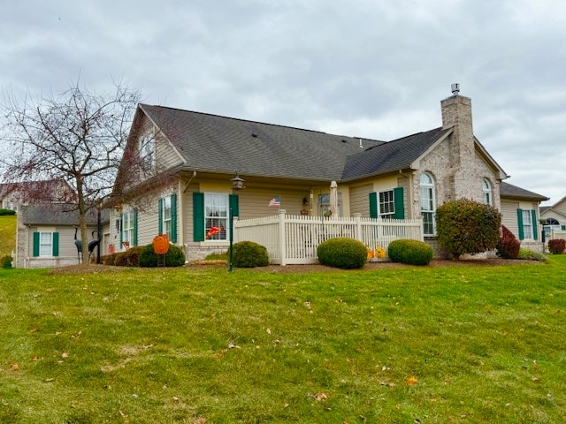 rear view of property with a yard